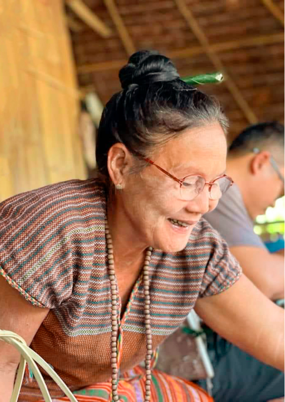 Elderly woman taking part in an activity related to traditional know-how