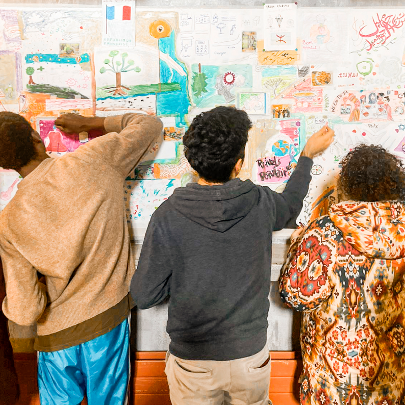 Young people taking part in an intercultural fresco activity about cultural diversity